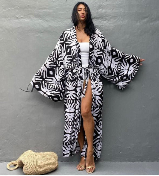 Woman wearing a black and white patterned kimono against a gray background